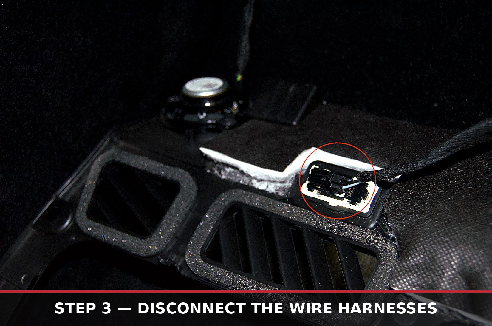 Wire harness connector circled behind the footwell speaker grille
