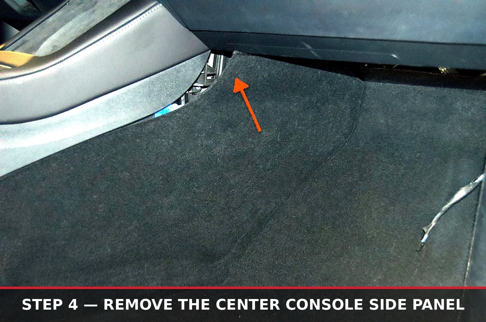 Arrow marking the release point along the center console side panel