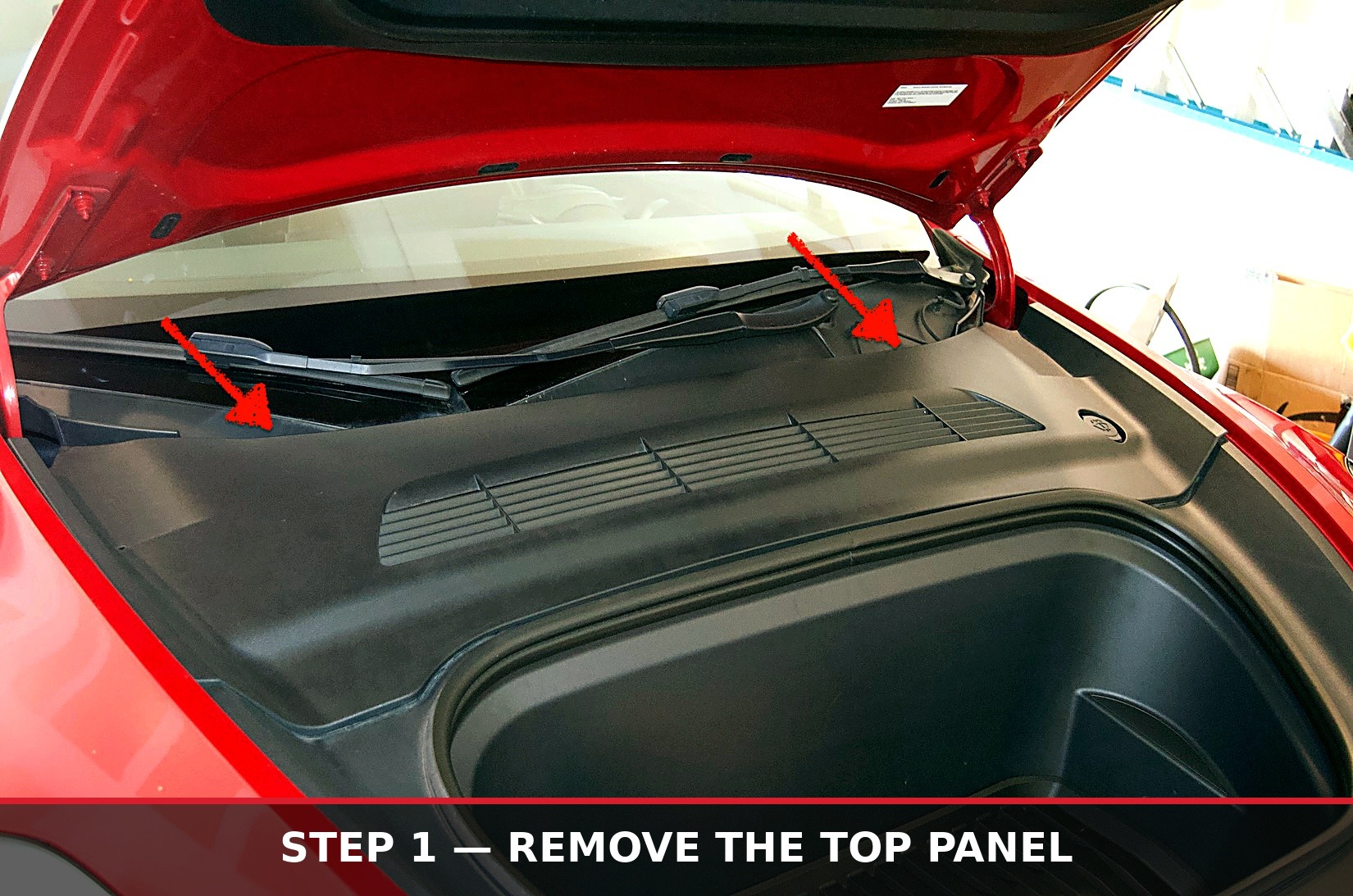 Frunk with top panel removed, arrows marking the clip locations
