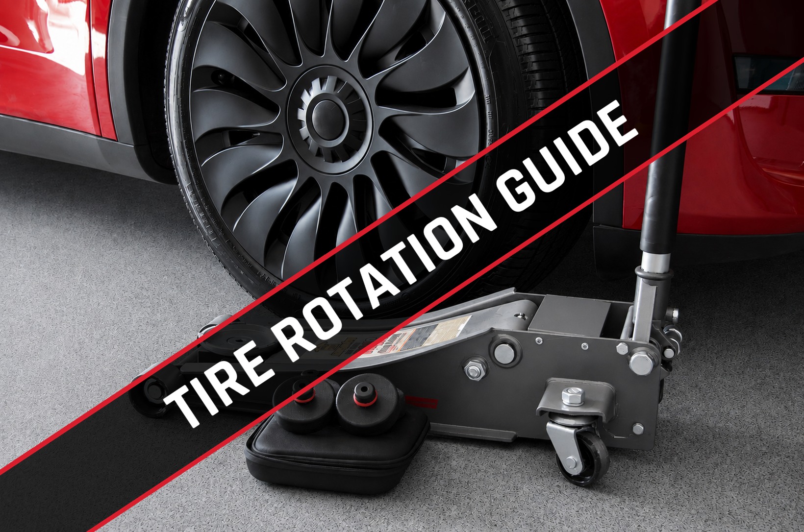 Floor jack and rubber lift pucks positioned under a Tesla Model Y wheel